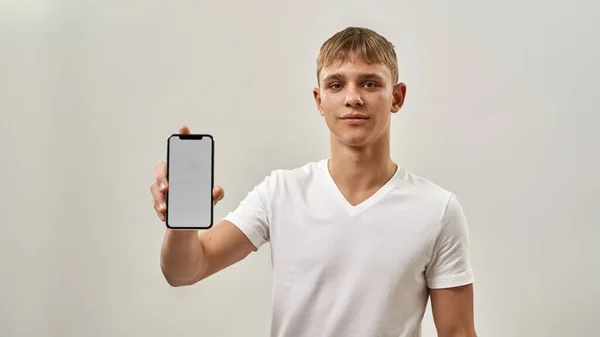 Σοβαρό Καυκάσιο Έφηβο Αγόρι Που Δείχνει Smartphone Ξανθός Τύπος Της — Φωτογραφία Αρχείου