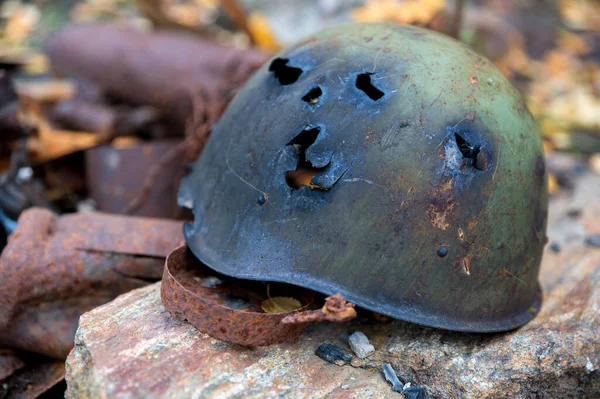 Old Soviet military steel helmet on a stone — Stock Photo, Image