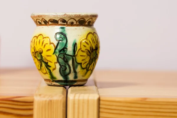 Um vaso colorido na mesa de madeira — Fotografia de Stock