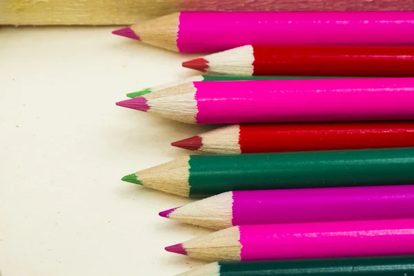 Colored pencils with wooden background — Stock Photo, Image