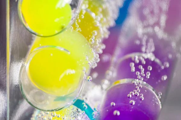 Underwater tubes with colorful jelly balls inside and bubbles — Stock Photo, Image