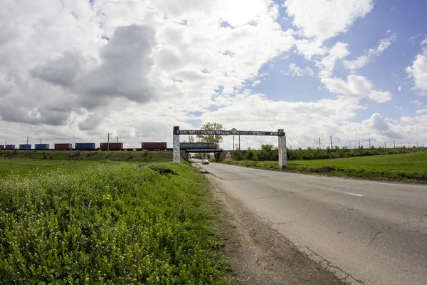 Rural landscape and train passing in the background — Stock Photo, Image