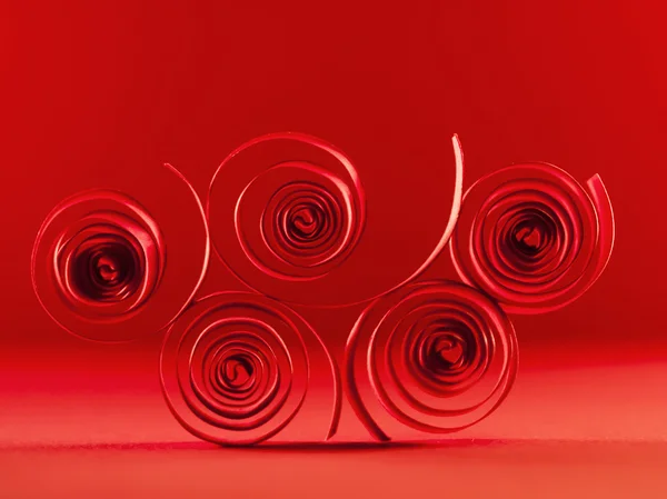 Red paper spirals on paper background — Stock Photo, Image
