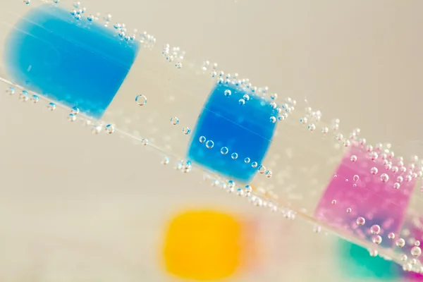 Abstrakte Komposition mit Unterwasserröhren mit bunten Gummibällen im Inneren und Blasen — Stockfoto
