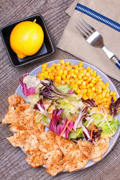 Chicken salad with sweet corn and green mix — Stock Photo, Image