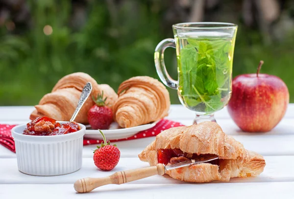 Breakfast with croissants and herbal tea — Stock Photo, Image