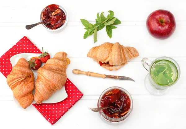 Breakfast with herbal tea and croissants — Stock Photo, Image