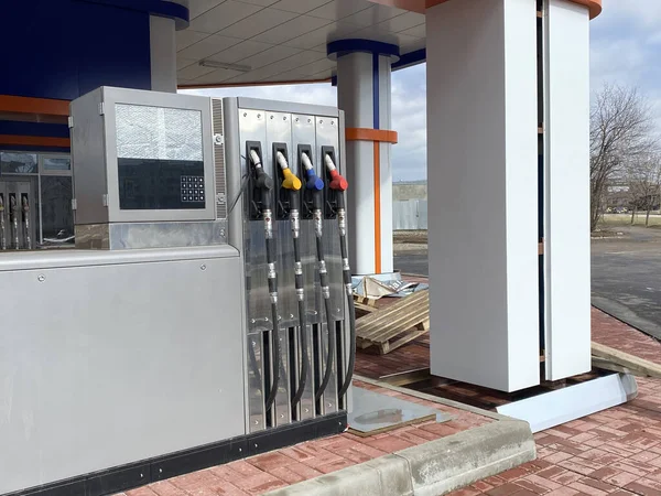 Petrol car refueling. Opening of a new Gas station. Fuel pump. Color fuel gasoline dispenser. Empty gas station, under construction. Work stoppage due to violations or covid 19 — стоковое фото