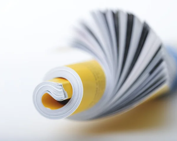 Rolled up magazine macro — Stock Photo, Image