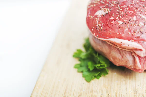 Uncooked meat  with parsley — Stock Photo, Image