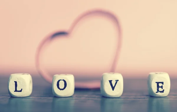 Small wooden letters spelling the word love — Stock Photo, Image