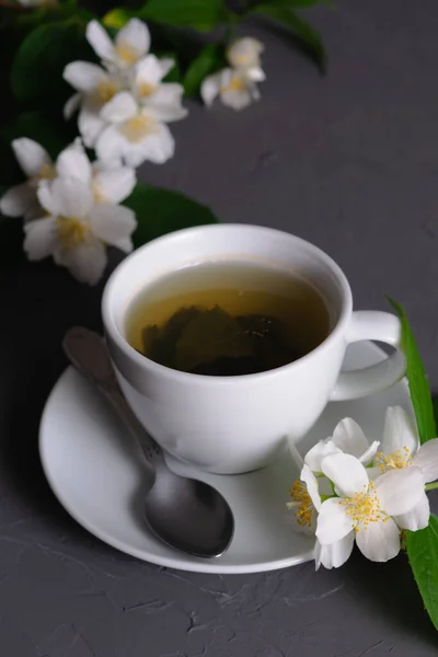 White Porcelain Cup Fragrant Green Tea Blooming Jasmine Gray Background — Stock Photo, Image