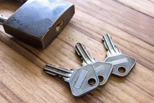 Padlock with keys on wooden — Stock Photo, Image