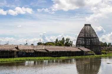 The biggest coop made from the bamboo structure is a trap for catching fish at Saphanburi Arch bridge local Market, Thailand.