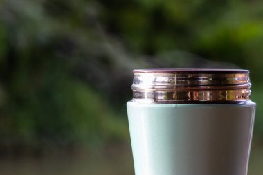Blue cup of coffee with rising steam above.