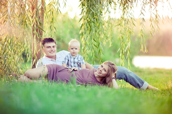 Glad familj på tre personer Stockbild
