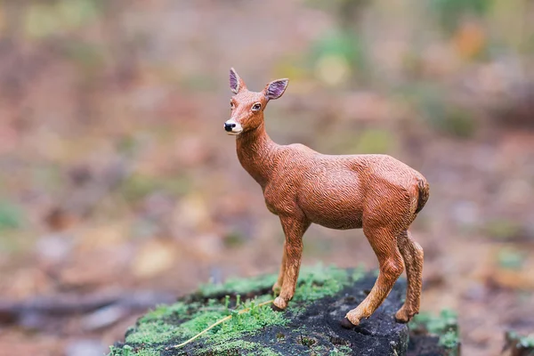 Figurine deer in autumn forest — Stock Photo, Image