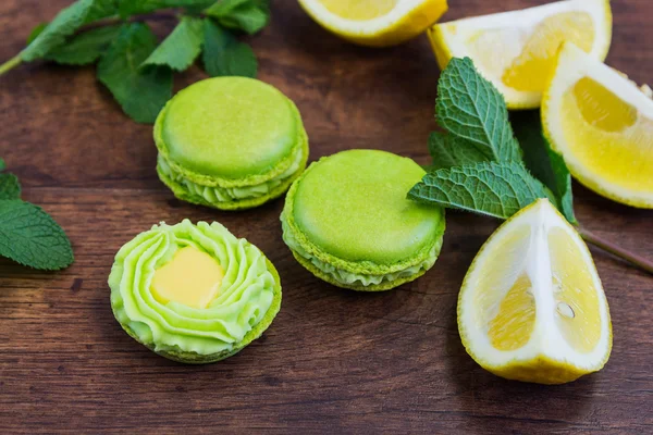 Зеленые макароны с лимоном и мятой на деревянном фоне — стоковое фото