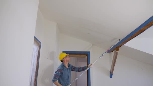 Adult Man Paints Wall Roller Makes Repairs Room Attic Floor — Stockvideo