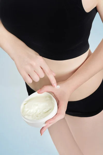 Woman applying body lotion — Stock Photo, Image