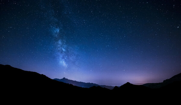 Ночное небо звезды с Млечный путь на горном фоне
