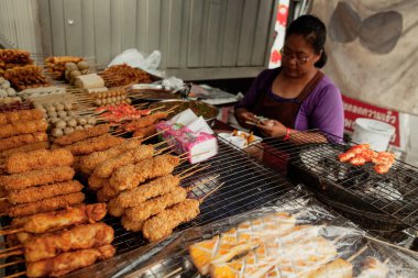 BANGKOK, THAILAND - 3 Mayıs 2014: Taylandlı kadın sokak yemekleriyle tezgahta