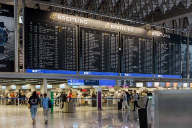 FRANKFURT, GERMANY - NOVEMBER 11, 2021: Passengers approach registration desks at the Frankfurt International airport