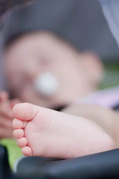 Cute baby legs in the carriage — Stock Photo, Image