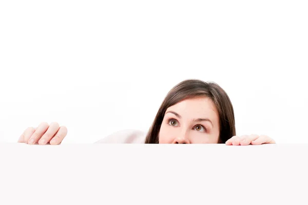 Woman peeping over white background. — Stock Photo, Image