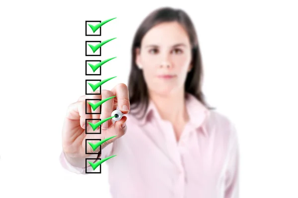 Young business woman checking on checklist boxes, white baclground. — Stock Photo, Image