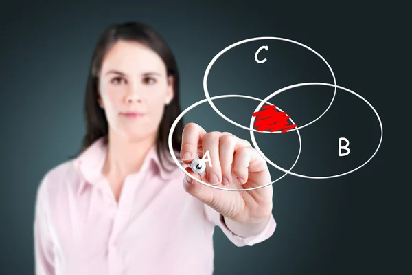 Young businesswoman drawing intersected circle diagram on whiteboard. — Stock Photo, Image