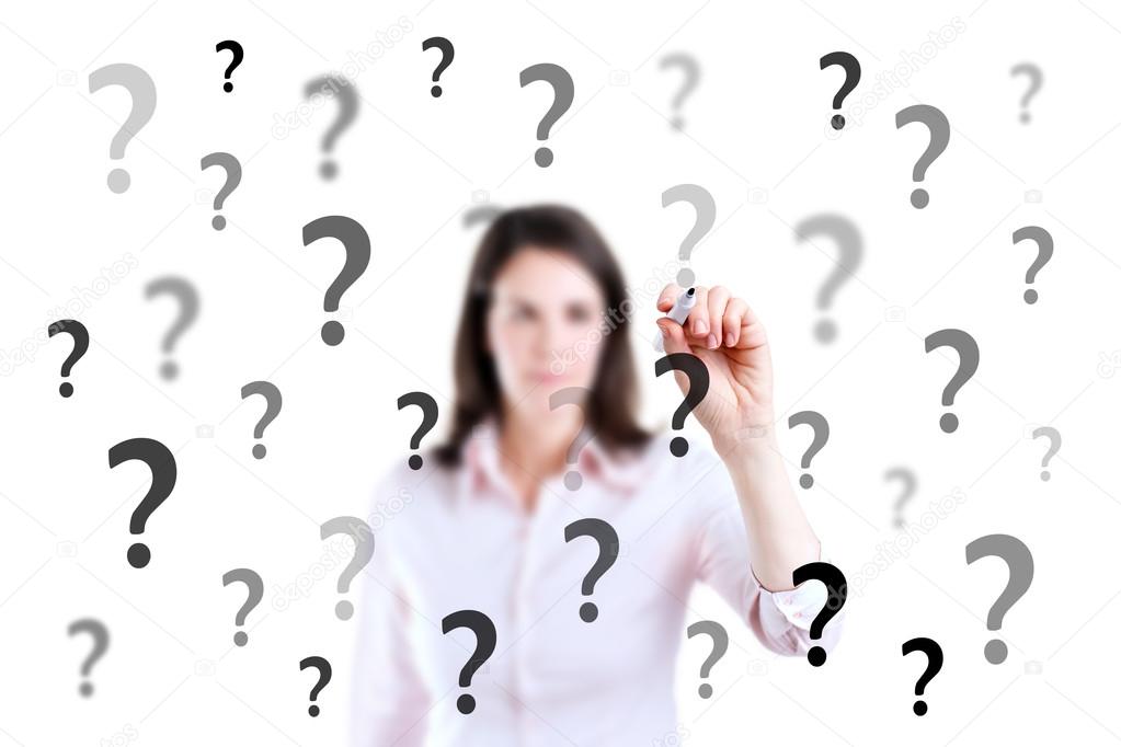 Young business woman writing question mark, white background.