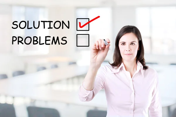 Young businesswoman check mark on solution concept. Office background. — Stock Photo, Image