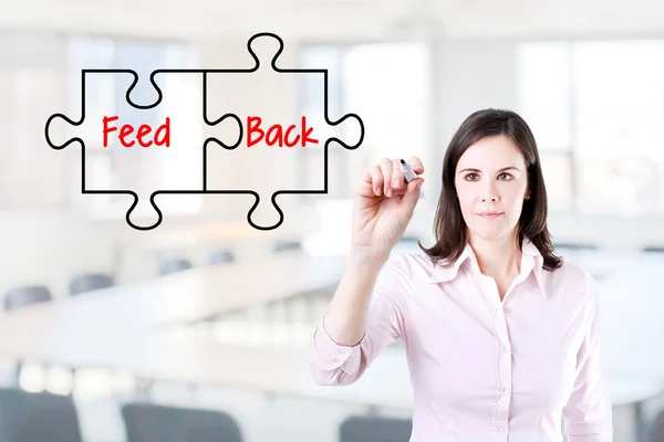 Businesswoman drawing a Feedback puzzle concept on the virtual screen. Office background. — Stock Photo, Image