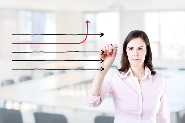 Businesswoman drawing arrows in different directions. Office background. — Stock Photo, Image