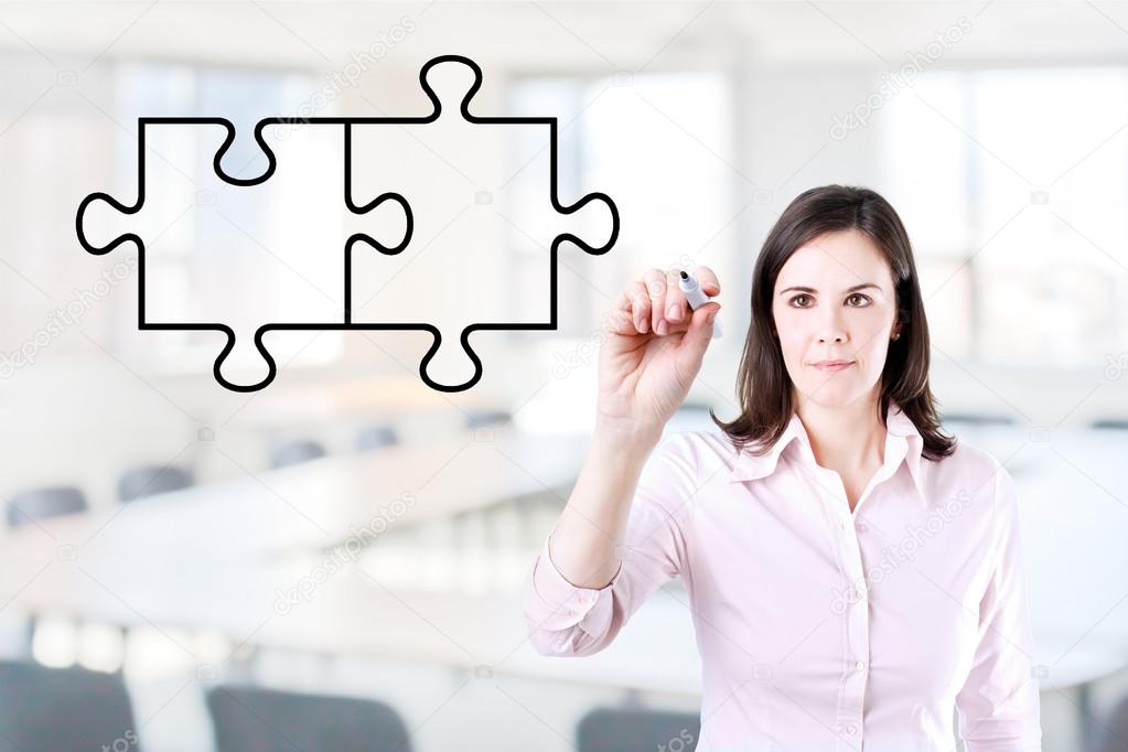 Businesswoman drawing a Blank Puzzle on the screen. Office background.