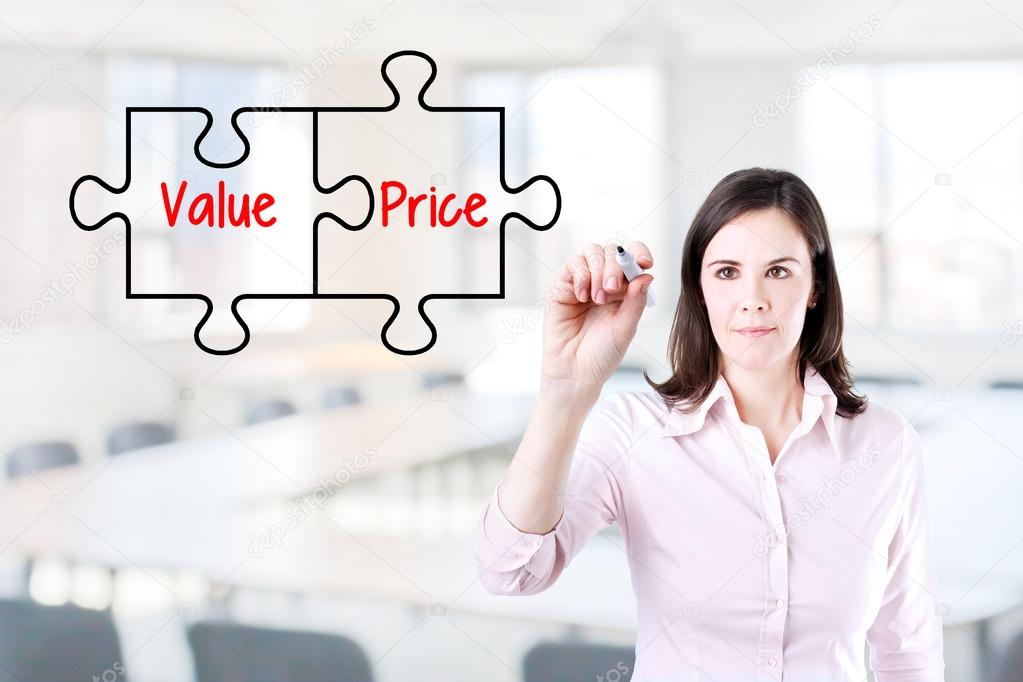 Businesswoman drawing a Value Price puzzle concept on the virtual screen. Office background.