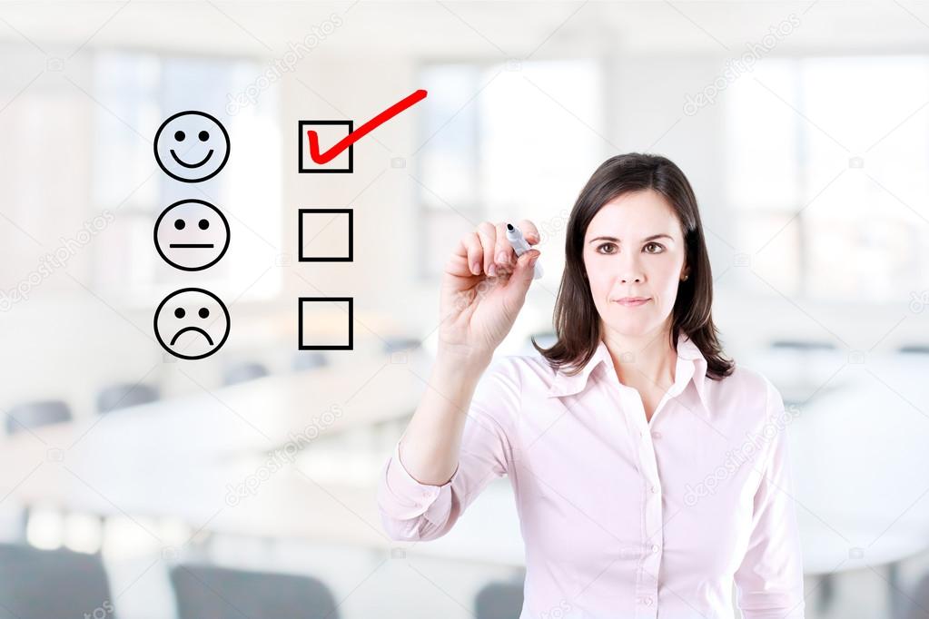 Hand putting check mark with red marker on customer service evaluation form. Office background.