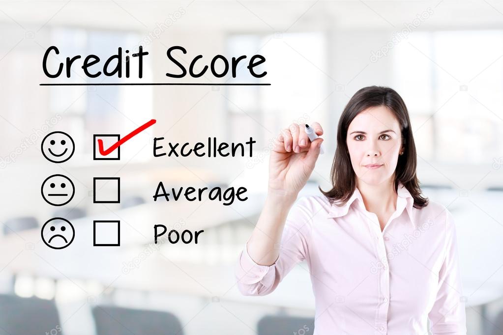 Hand putting check mark with red marker on excellent credit score evaluation form. Office background.