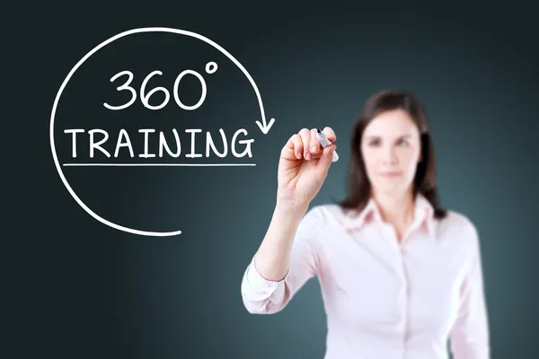 Businesswoman drawing a 360 degrees Training concept on the virtual screen. Blue background. — Stock Photo, Image