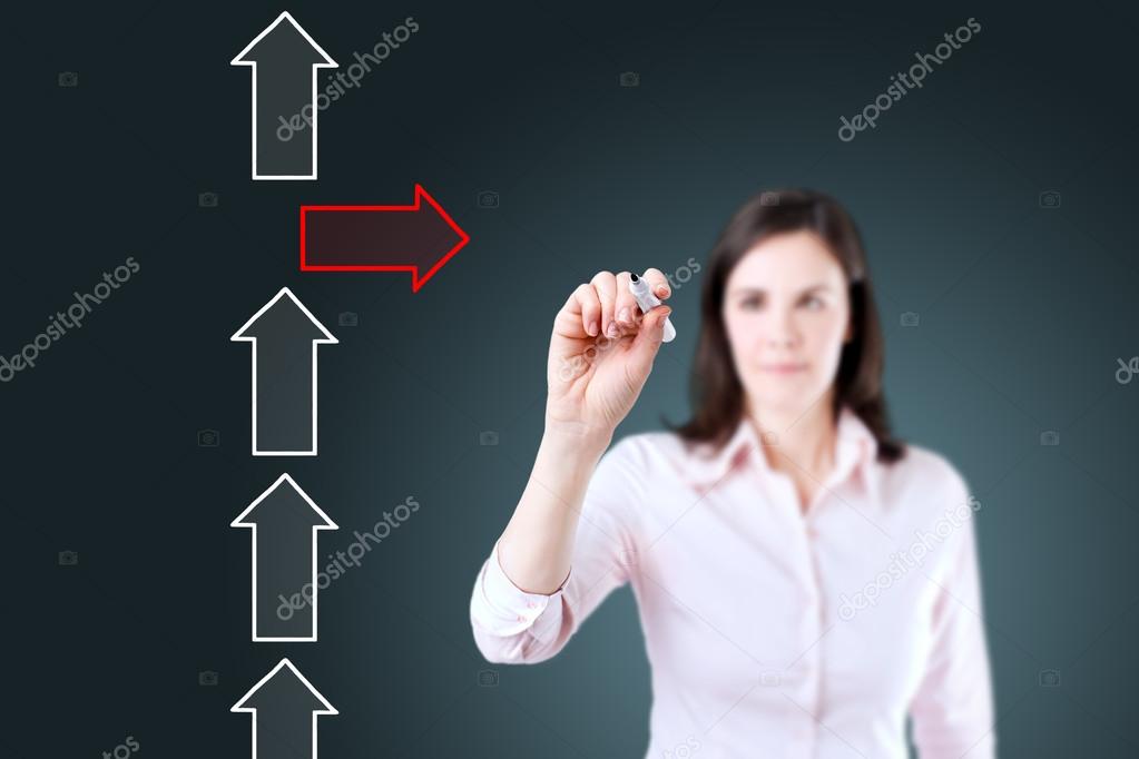 Businesswoman drawing arrows in different directions. Blue background.