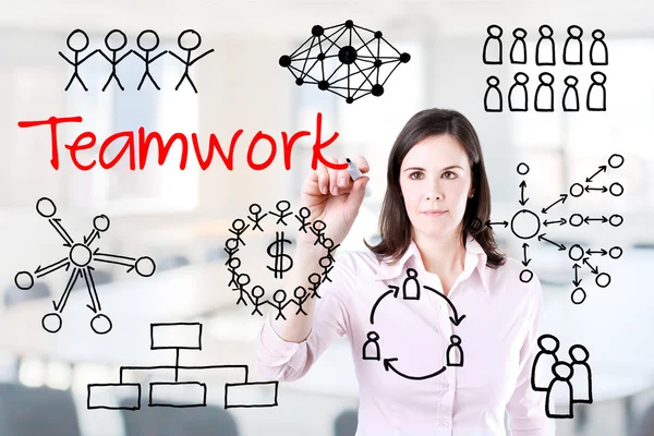 Young business woman writing teamwork figure. Office background. — Stock Photo, Image