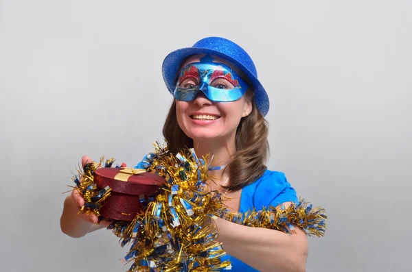 Happy girl with a gift in blue Stock Picture