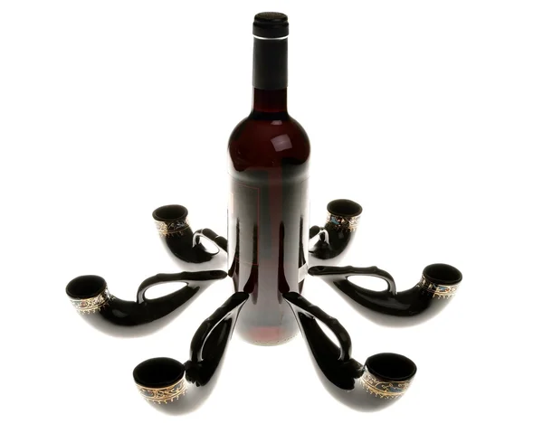 Still life with wine bottle and decorative horns — Stock Photo, Image