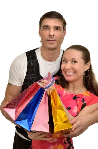 Happy smiling couple husband and wife with gift bags in hands — Stock Photo, Image