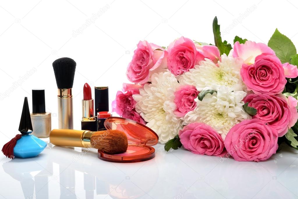 Decorative cosmetics and perfumes subject against a beautiful bouquet