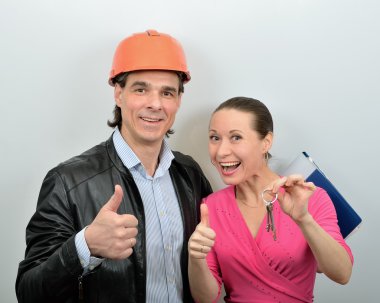 Chief of builders gives a woman the keys to new apartment clipart