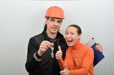 Chief of builders gives a woman the keys to new apartment clipart