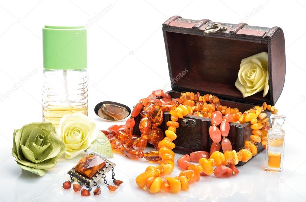 Women's jeweler ornaments - necklace perfumes and flowers in still life