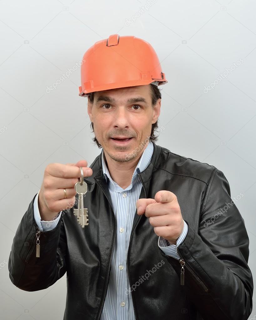 Builder - foreman gives the keys to the new house to new settlers